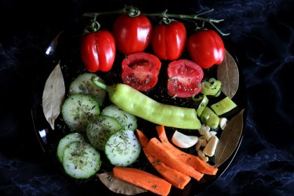 Healthy salad with tomatoes, cucumber, bell pepper, carrot, onion and spices